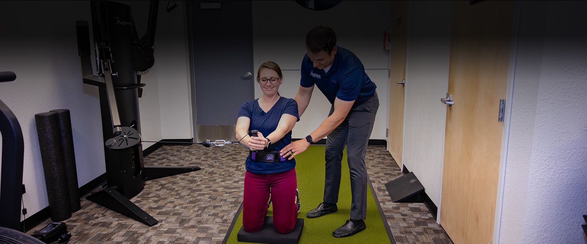 chiropractor helping with physical rehabilitation exercises